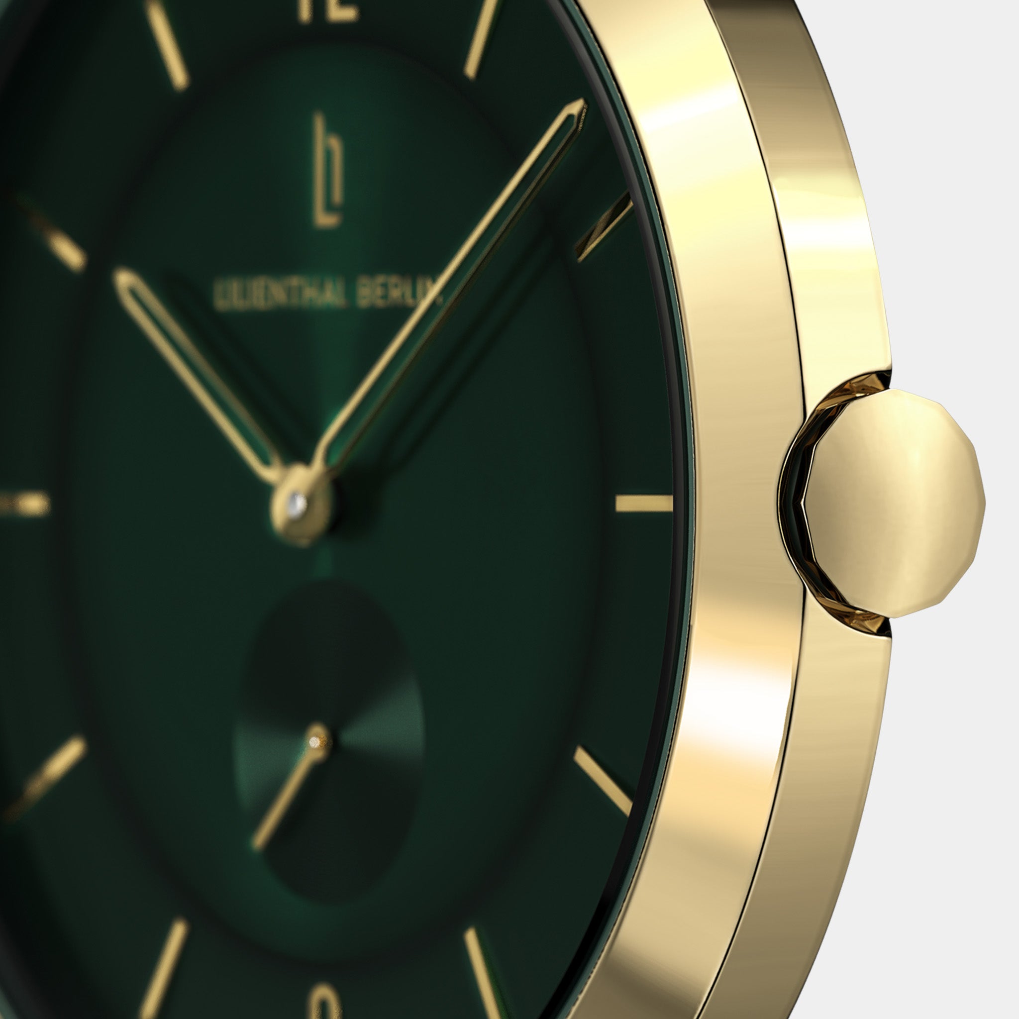 Close-up of a gold watch with a green dial and gold hour markers, minimalist design