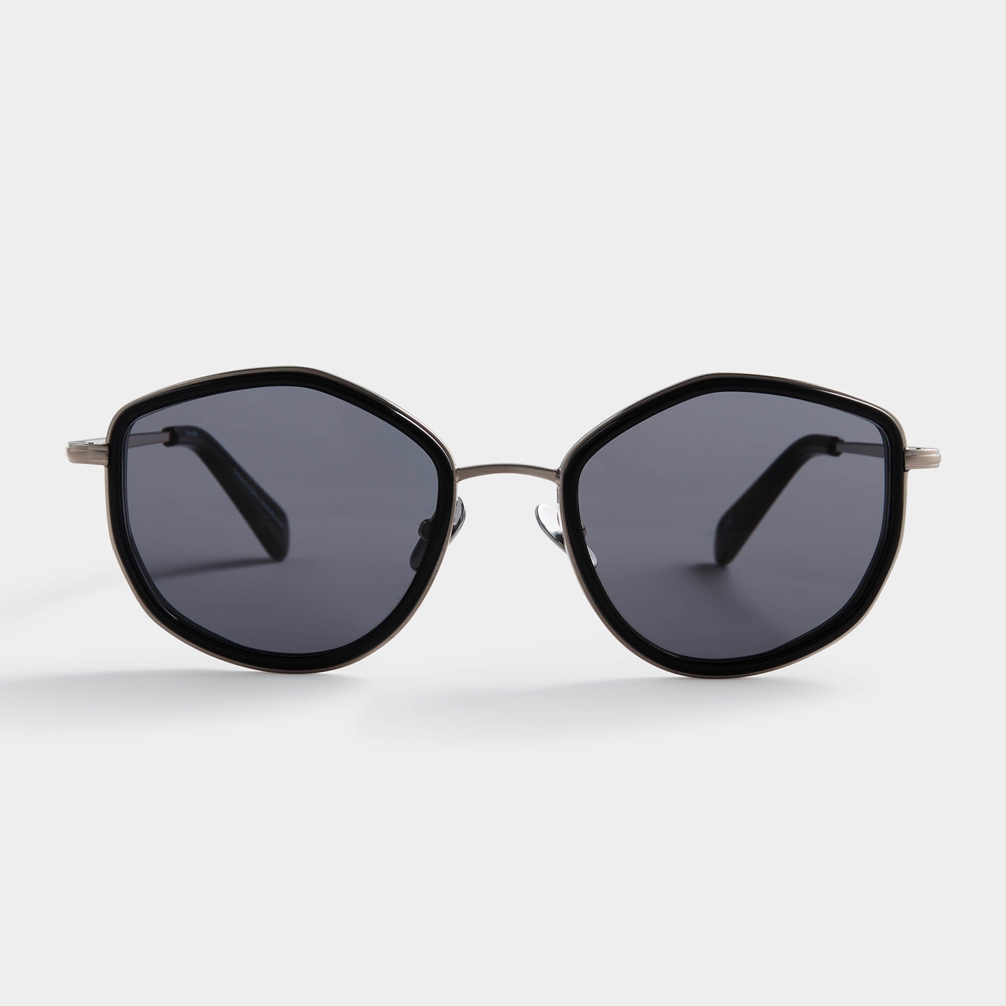 Geometric black frame sunglasses with dark lenses on a white background