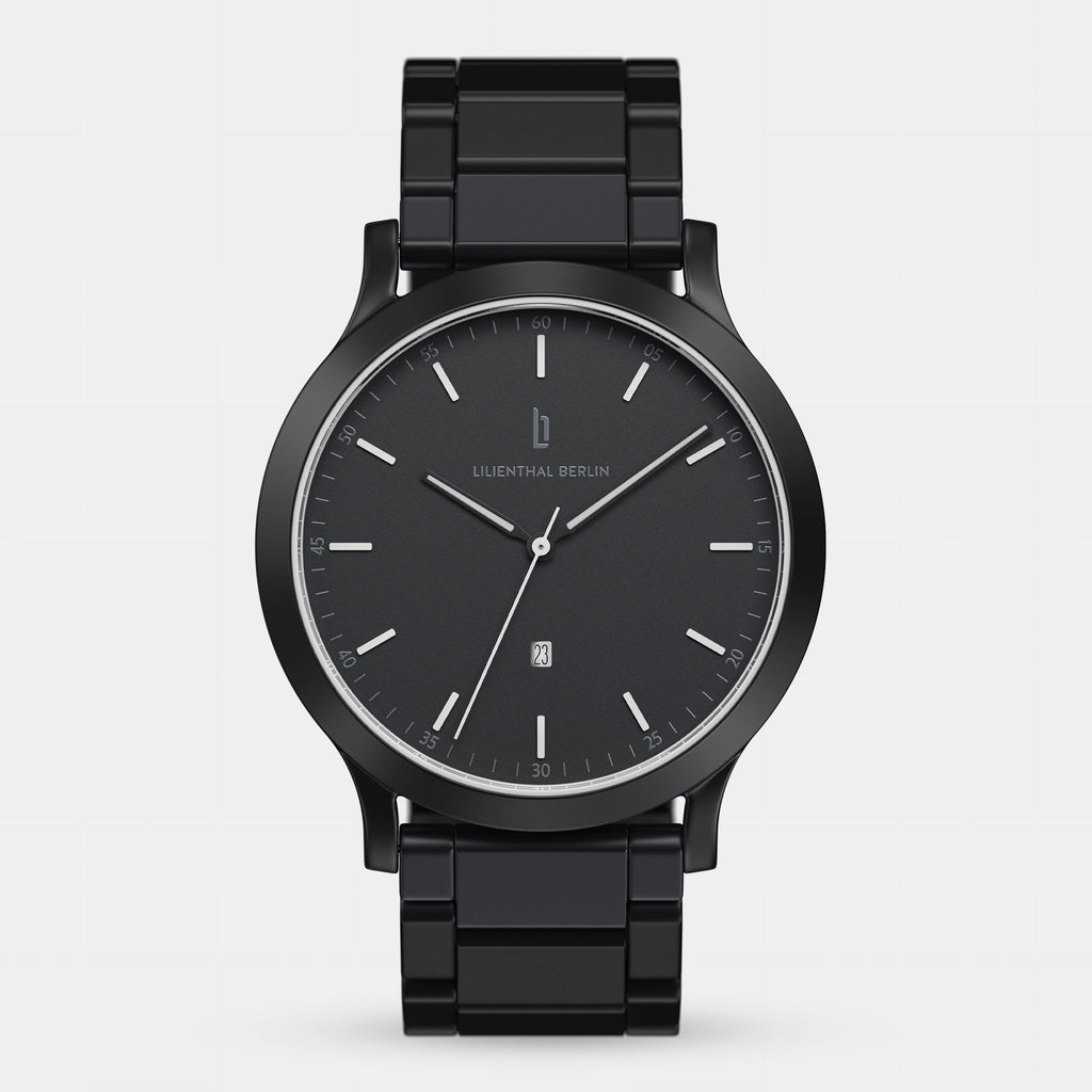 Sleek black analog wristwatch with metal band, minimalist dial, date display at 6 o'clock.