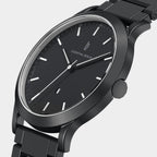 Sleek black minimalist wristwatch with metal band and date display, modern design