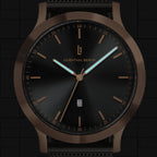 Minimalist black watch with bronze case, date display, and luminous hands